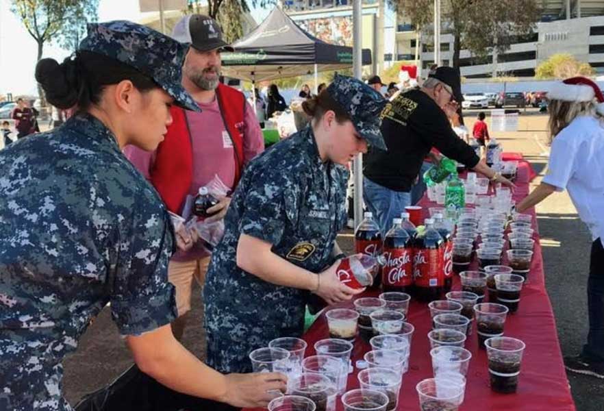 military pouring drinks